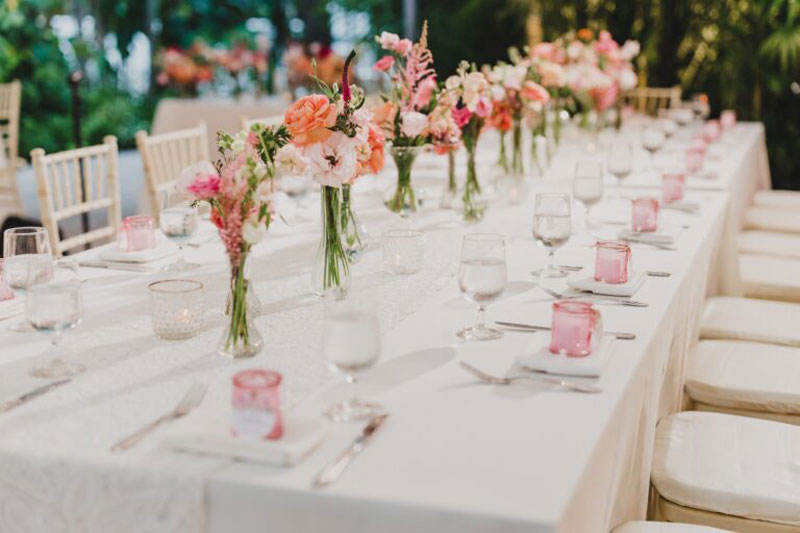 wedding table decoration with flowers and glass