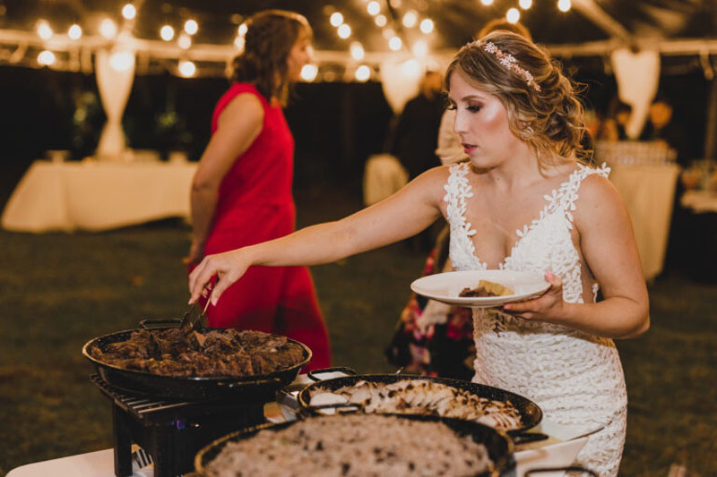 bride having food from buffet