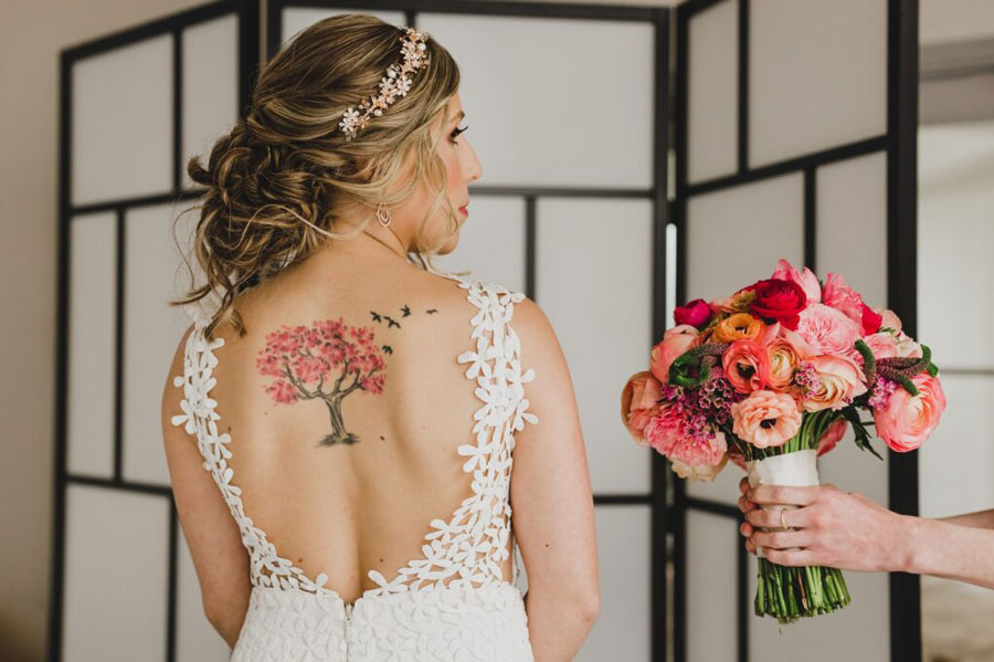 someone giving flowers to bride