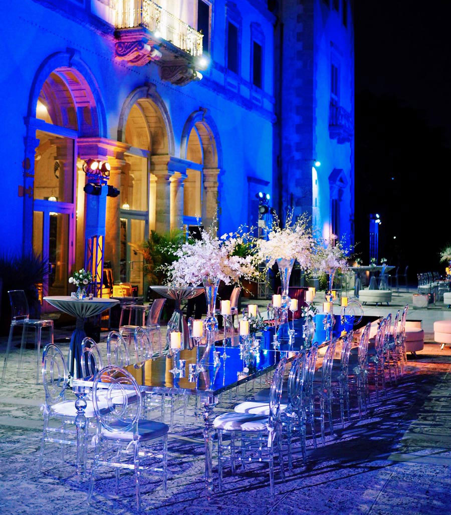 clear and black dining decor outdoors with blue lighting