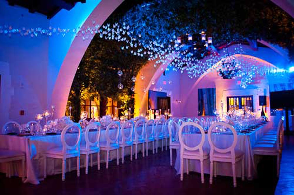 multiple tables with blue and pink lighting for a corporate event