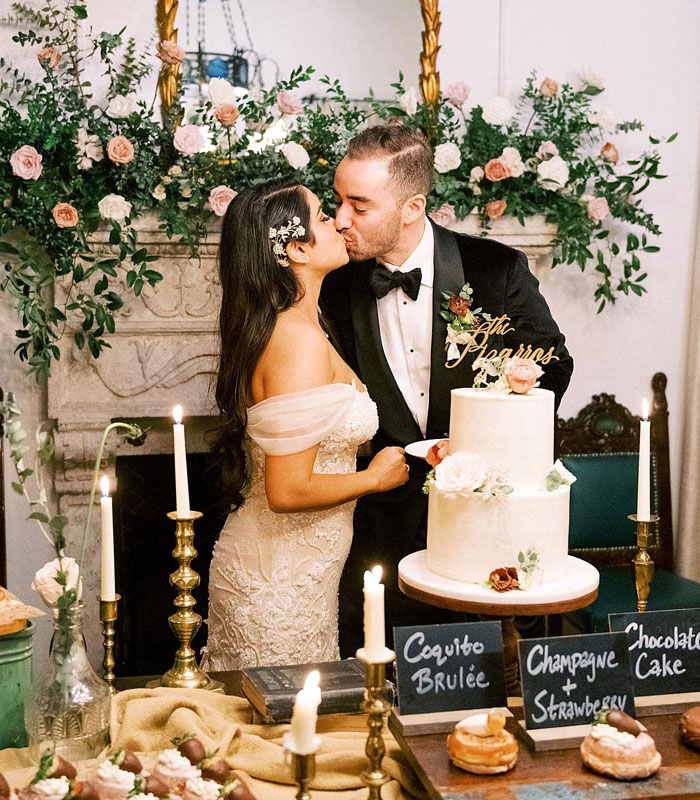 newlyweds kissing in front of food