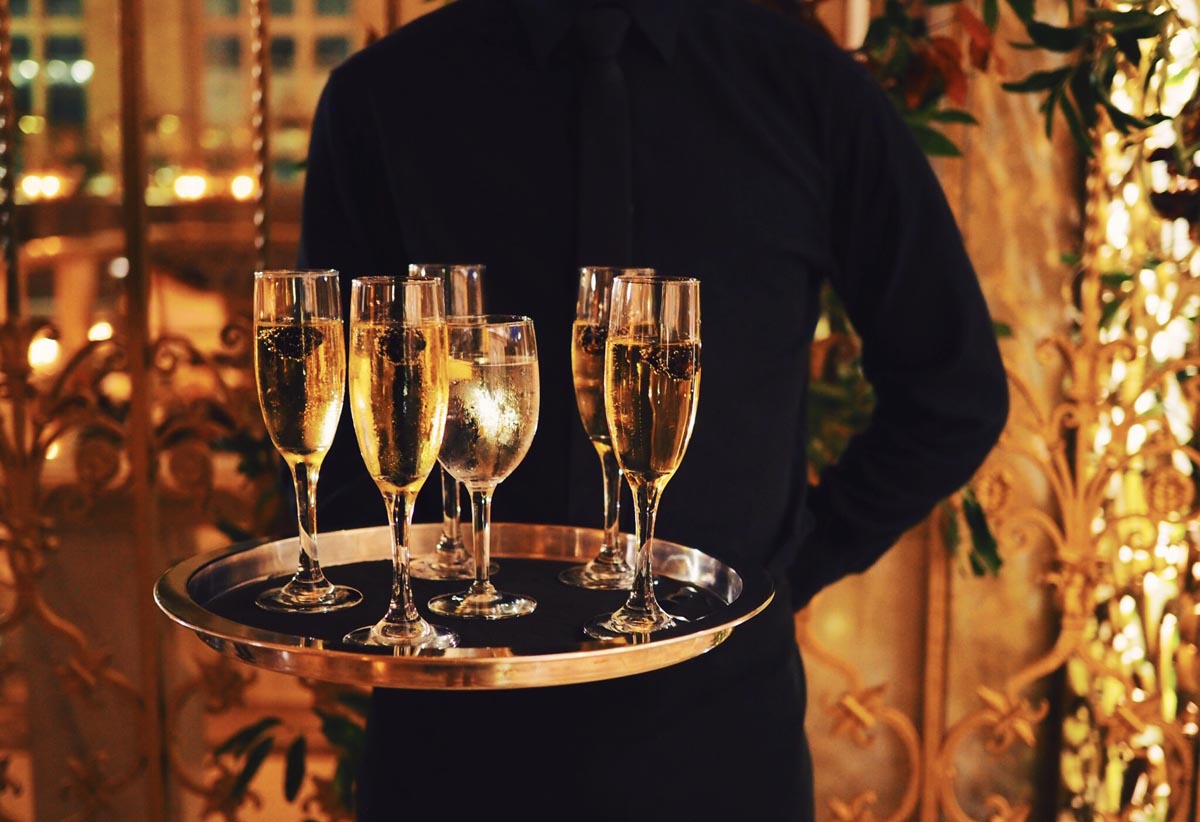 waiter serving champagne and water