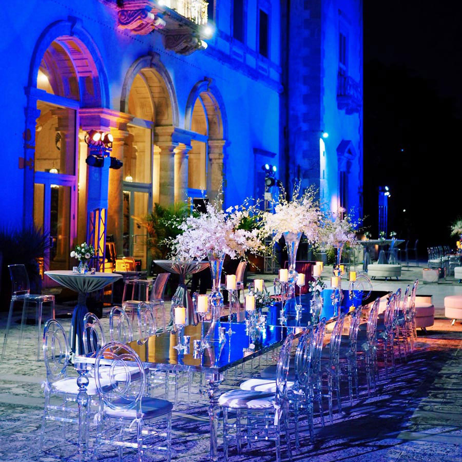 clear and black dining decor outdoors with blue lighting