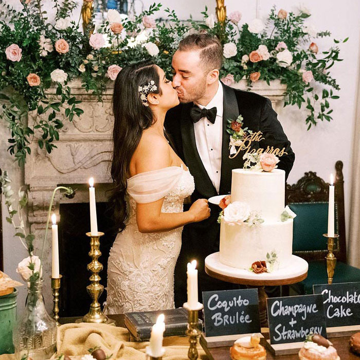 newlyweds kissing in front of food